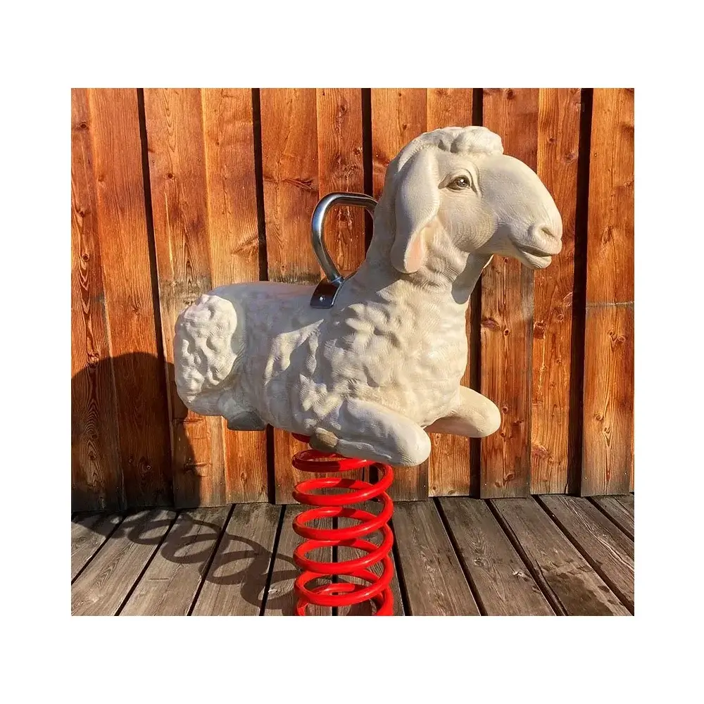 Foto: geschnitzes und bemaltes Federwipptier Schaf mit roter Schwungfeder