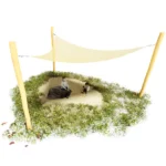 Dreieck-Sonnensegel gespannt zwischen 3 Robinienstämmen. Darunter im Schatten 2 spielende Kinder in einem Sandkasten